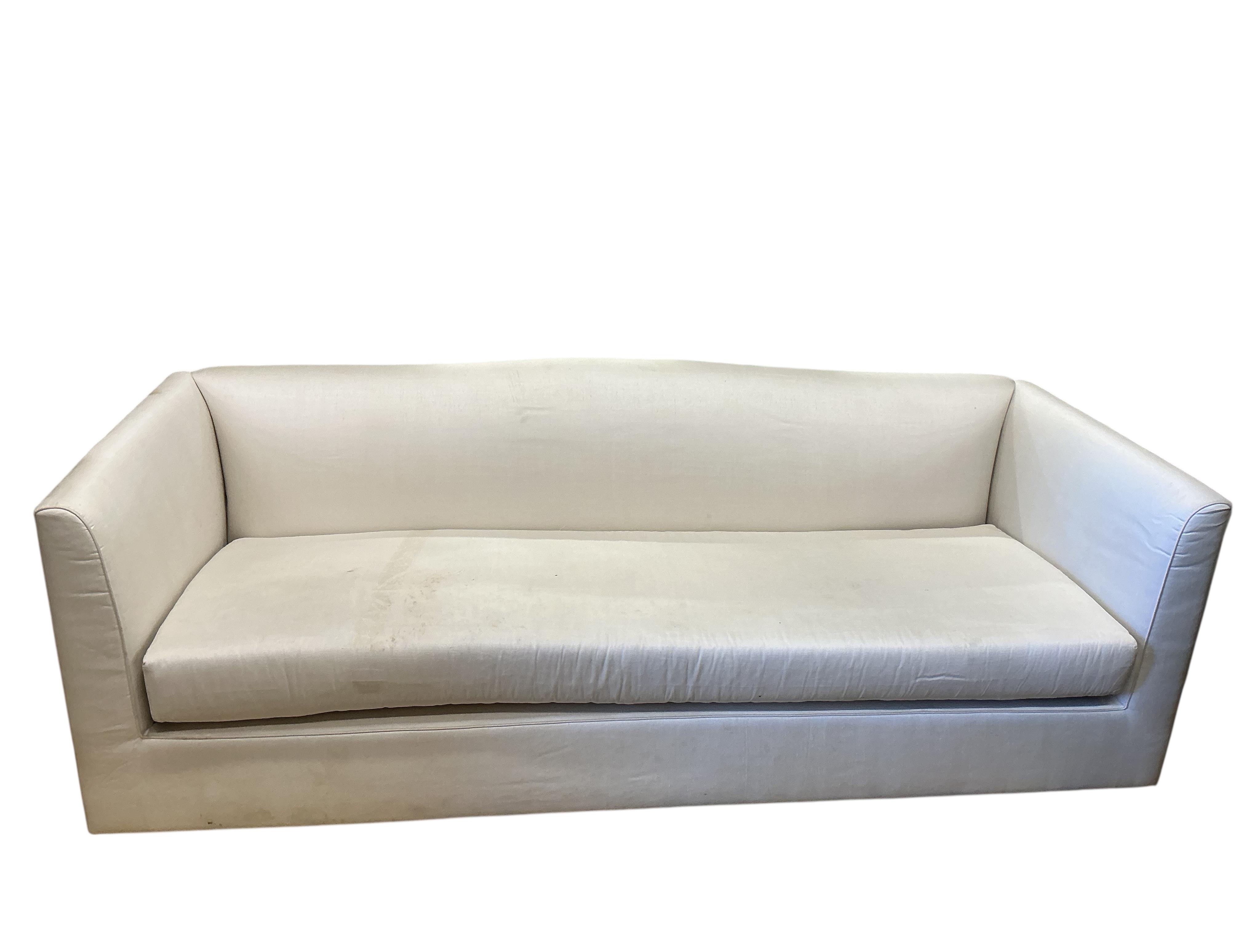A large contemporary ivory fabric settee, width 260cm, depth 100cm, height 82cm